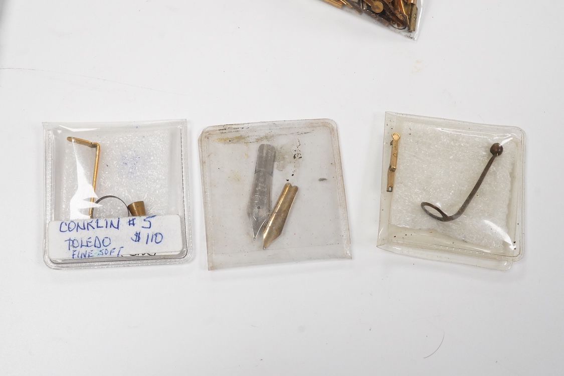 A selection of fountain spares to include levers, blind caps and nibs, some gold